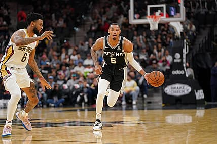 Dec 12, 2021; San Antonio, Texas, USA;  San Antonio Spurs guard Dejounte Murray (5) dribbles against New Orleans Pelicans guard Nickeil Alexander-Walker (6) in the second half at the AT&T Center. Mandatory Credit: Daniel Dunn-USA TODAY Sports