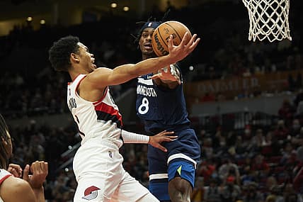 Dec 12, 2021; Portland, Oregon, USA; Portland Trail Blazers guard Anfernee Simons (1) scores a basket during the second half against Minnesota Timberwolves forward Jarred Vanderbilt (8) at Moda Center. The Minnesota Timberwolves won 116-111. Mandatory Credit: Troy Wayrynen-USA TODAY Sports