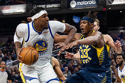 Dec 13, 2021; Indianapolis, Indiana, USA; Golden State Warriors center Kevon Looney (5) shoots the ball while Indiana Pacers center Myles Turner (33) defends in the first quarter at Gainbridge Fieldhouse. Mandatory Credit: Trevor Ruszkowski-USA TODAY Sports