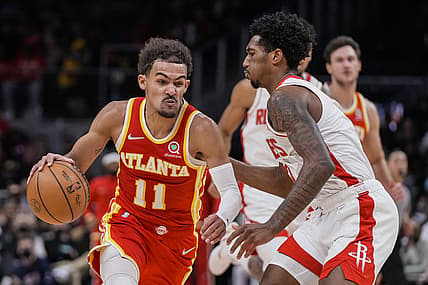 Dec 13, 2021; Atlanta, Georgia, USA; Atlanta Hawks guard Trae Young (11) moves the ball against Houston Rockets guard Armoni Brooks (7) during the second half at State Farm Arena. Mandatory Credit: Dale Zanine-USA TODAY Sports