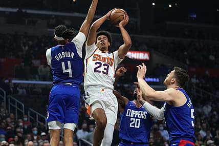 Dec 13, 2021; Los Angeles, California, USA; Phoenix Suns forward Cameron Johnson (23) is defended by LA Clippers guard Brandon Boston Jr. (4), forward Justise Winslow (20) and center Isaiah Hartenstein (55) in the first half at Staples Center. Mandatory Credit: Kirby Lee-USA TODAY Sports