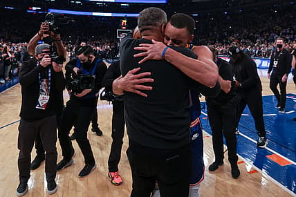Dec 14, 2021; New York, New York, USA; Golden State Warriors guard Stephen Curry (30) hugs his father Dell Curry (left) after breaking the record for most career three point baskets made during the first half against the New York Knicks at Madison Square Garden. Mandatory Credit: Vincent Carchietta-USA TODAY Sports