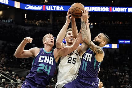 Dec 15, 2021; San Antonio, Texas, USA; Charlotte Hornets center Mason Plumlee (24) and forward Cody Martin (11) battle for the loose ball with San Antonio Spurs center Jakob Poeltl (25) during the first half at AT&T Center. Mandatory Credit: Scott Wachter-USA TODAY Sports