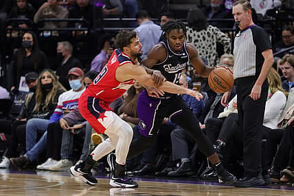 Dec 15, 2021; Sacramento, California, USA; Washington Wizards guard Raul Neto (19) attempts to steal the ball away from Sacramento Kings guard Davion Mitchell (15) during the second quarter at Golden 1 Center. Mandatory Credit: Sergio Estrada-USA TODAY Sports