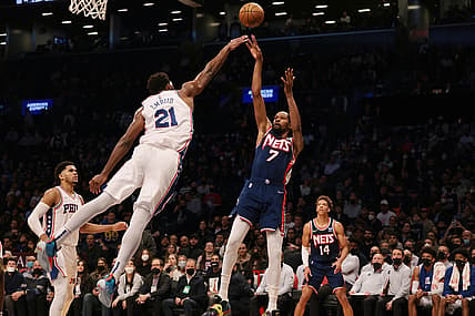 Dec 16, 2021; Brooklyn, New York, USA; Brooklyn Nets forward Kevin Durant (7) shoots the ball as Philadelphia 76ers center Joel Embiid (21) defends during the second half at Barclays Center. Mandatory Credit: Vincent Carchietta-USA TODAY Sports
