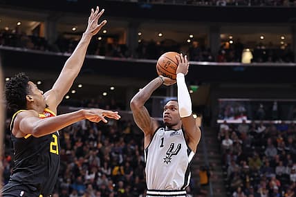 Dec 17, 2021; Salt Lake City, Utah, USA; San Antonio Spurs guard Lonnie Walker IV (1) shoots the ball against Utah Jazz center Hassan Whiteside (21) during the second quarter at Vivint Arena. Mandatory Credit: Rob Gray-USA TODAY Sports