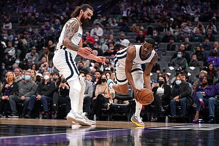 Dec 17, 2021; Sacramento, California, USA; Memphis Grizzlies guard De'Anthony Melton (0) saves the ball from going out of bounds next to center Steven Adams (4) against the Sacramento Kings in the second quarter at the Golden 1 Center. Mandatory Credit: Cary Edmondson-USA TODAY Sports
