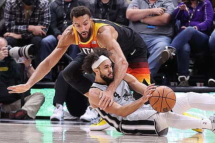 Dec 17, 2021; Salt Lake City, Utah, USA; Utah Jazz center Rudy Gobert (27) and San Antonio Spurs guard Derrick White (4) battle for a loose ball in the fourth quarter at Vivint Arena. Mandatory Credit: Rob Gray-USA TODAY Sports