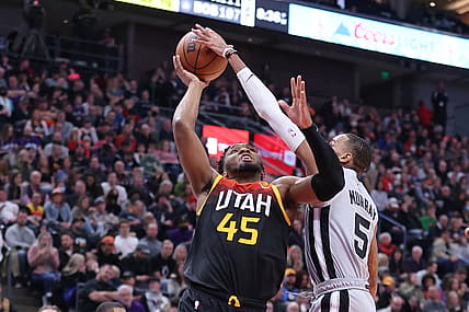 Dec 17, 2021; Salt Lake City, Utah, USA; San Antonio Spurs guard Dejounte Murray (5) blocks the shot of Utah Jazz guard Donovan Mitchell (45) in the third quarter at Vivint Arena. Mandatory Credit: Rob Gray-USA TODAY Sports