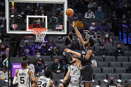 Dec 19, 2021; Sacramento, California, USA; Sacramento Kings forward Chimezie Metu (7) scores over San Antonio Spurs center Jock Landale (34) during the second quarter at Golden 1 Center. Mandatory Credit: Darren Yamashita-USA TODAY Sports