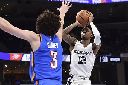 Dec 20, 2021; Memphis, Tennessee, USA; Memphis Grizzlies guard Ja Morant (12) shoots against Oklahoma City Thunder guard Josh Giddey (3) during the second half at FedExForum. Mandatory Credit: Justin Ford-USA TODAY Sports
