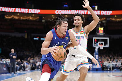 Dec 22, 2021; Oklahoma City, Oklahoma, USA; Denver Nuggets forward Aaron Gordon (50) drives to the basket around Oklahoma City Thunder forward Jeremiah Robinson-Earl (50) during the second quarter at Paycom Center. Mandatory Credit: Alonzo Adams-USA TODAY Sports