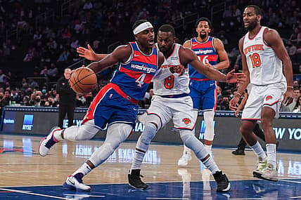 Dec 23, 2021; New York, New York, USA; Washington Wizards guard Aaron Holiday (4) dribbles the ball past New York Knicks guard Kemba Walker (8) during the first quarter at Madison Square Garden. Mandatory Credit: Dennis Schneidler-USA TODAY Sports