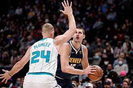 Dec 23, 2021; Denver, Colorado, USA; Denver Nuggets center Nikola Jokic (15) controls the ball as Charlotte Hornets center Mason Plumlee (24) guards in the first quarter at Ball Arena. Mandatory Credit: Isaiah J. Downing-USA TODAY Sports