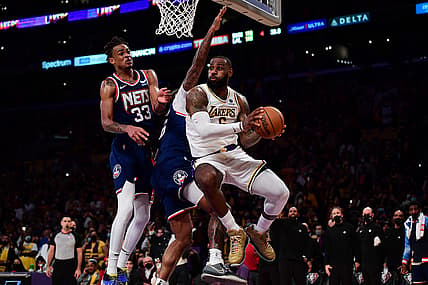 Dec 25, 2021; Los Angeles, California, USA; Los Angeles Lakers forward LeBron James (6) passes against Brooklyn Nets forward Nic Claxton (33) during the second half at Crypto.com Arena. Mandatory Credit: Gary A. Vasquez-USA TODAY Sports
