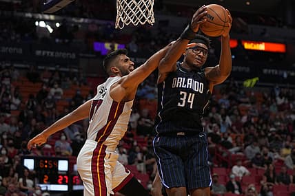 Dec 26, 2021; Miami, Florida, USA; Orlando Magic center Wendell Carter Jr. (34) rebounds the ball in front of Miami Heat center Omer Yurtseven (77) during the first half at FTX Arena. Mandatory Credit: Jasen Vinlove-USA TODAY Sports