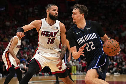 Dec 26, 2021; Miami, Florida, USA; Orlando Magic forward Franz Wagner (22) drives the ball around Miami Heat forward Caleb Martin (16) during the second half at FTX Arena. Mandatory Credit: Jasen Vinlove-USA TODAY Sports
