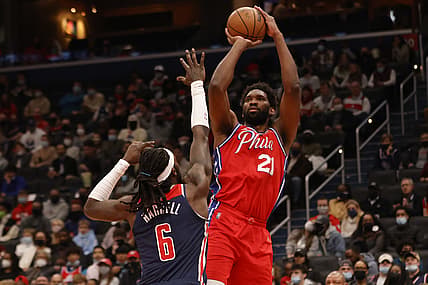 Dec 26, 2021; Washington, District of Columbia, USA; Philadelphia 76ers center Joel Embiid (21) shoots the ball over Washington Wizards center Montrezl Harrell (6) during the second quarter at Capital One Arena. Mandatory Credit: Geoff Burke-USA TODAY Sports