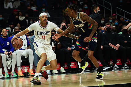 Dec 26, 2021; Los Angeles, California, USA; Los Angeles Clippers guard Brandon Boston Jr. (4) moves the ball against Denver Nuggets guard Bones Hyland (3) during the first half at Crypto.com Arena. Mandatory Credit: Gary A. Vasquez-USA TODAY Sports