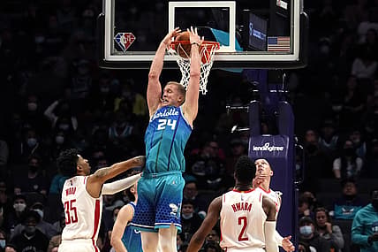 Dec 27, 2021; Charlotte, North Carolina, USA; Charlotte Hornets center Mason Plumlee (24) dunks the ball over Houston Rockets center Christian Wood (35) during the second quarter at the Spectrum Center. Mandatory Credit: Jim Dedmon-USA TODAY Sports