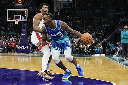 Dec 27, 2021; Charlotte, North Carolina, USA; Charlotte Hornets guard Terry Rozier (3) dribbles the ball past Houston Rockets guard Armoni Brooks (left) during the second half at the Spectrum Center. Mandatory Credit: Jim Dedmon-USA TODAY Sports