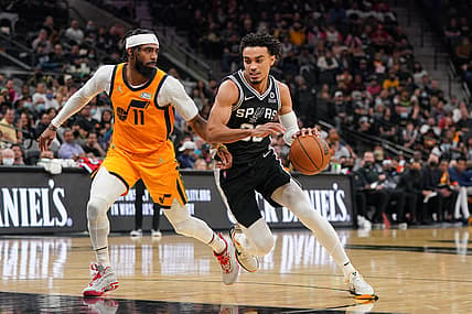 Dec 27, 2021; San Antonio, Texas, USA;San Antonio Spurs guard Tre Jones (33) dribbles against Utah Jazz guard Mike Conley (11) in the second half at the AT&T Center. Mandatory Credit: Daniel Dunn-USA TODAY Sports