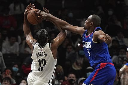 Dec 27, 2021; Los Angeles, California, USA; LA Clippers center Serge Ibaka (9) defends against Brooklyn Nets guard James Harden (13) in the first half at Crypto.com Arena. Mandatory Credit: Kirby Lee-USA TODAY Sports