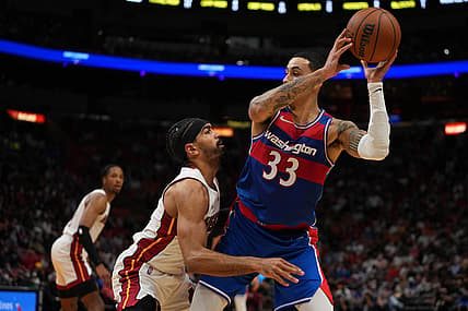 Dec 28, 2021; Miami, Florida, USA; Washington Wizards forward Kyle Kuzma (33) controls the ball around Miami Heat guard Gabe Vincent (2) during the first half at FTX Arena. Mandatory Credit: Jasen Vinlove-USA TODAY Sports