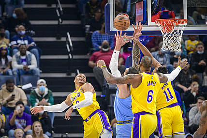 Dec 29, 2021; Memphis, Tennessee, USA; Los Angeles Lakers guard Russell Westbrook (0) and forward LeBron James (6) and guard Malik Monk (11) fight for the rebound with Memphis Grizzlies center Steven Adams (4) during the first quarter at the FedExForum. Mandatory Credit: Jerome Miron-USA TODAY Sports