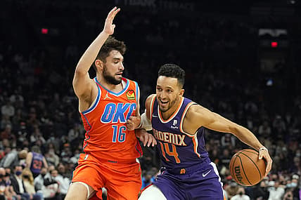 Dec 29, 2021; Phoenix, Arizona, USA; Phoenix Suns guard Landry Shamet (14) dribbles the ball against Oklahoma City Thunder guard Ty Jerome (16) in the first half at Footprint Center. Mandatory Credit: Rick Scuteri-USA TODAY Sports