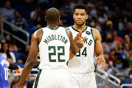 Dec 30, 2021; Orlando, Florida, USA; Milwaukee Bucks forward Khris Middleton (22) and forward Giannis Antetokounmpo (34) celebrate a three point shot in the second half against the Orlando Magic at Amway Center. Mandatory Credit: Nathan Ray Seebeck-USA TODAY Sports