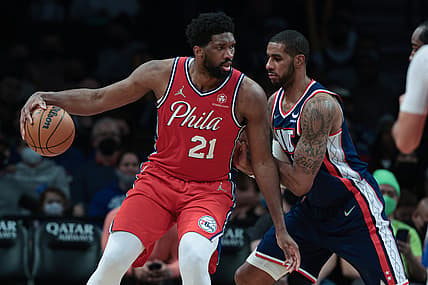 Dec 30, 2021; Brooklyn, New York, USA; Philadelphia 76ers center Joel Embiid (21) dribbles as Brooklyn Nets center LaMarcus Aldridge (21) defends during the second half at Barclays Center. Mandatory Credit: Vincent Carchietta-USA TODAY Sports