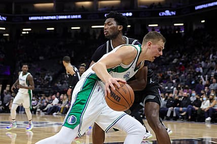 Dec 31, 2021; Sacramento, California, USA; Dallas Mavericks center Kristaps Porzingis (6) dribbles the ball against Sacramento Kings center Damian Jones (30) during the second quarter at Golden 1 Center. Mandatory Credit: Sergio Estrada-USA TODAY Sports