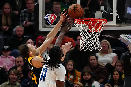 Dec 31, 2021; Salt Lake City, Utah, USA; Minnesota Timberwolves center Naz Reid (11) fouls Utah Jazz forward Bojan Bogdanovic (44) in the first quarter at Vivint Arena. Mandatory Credit: Ron Chenoy-USA TODAY Sports