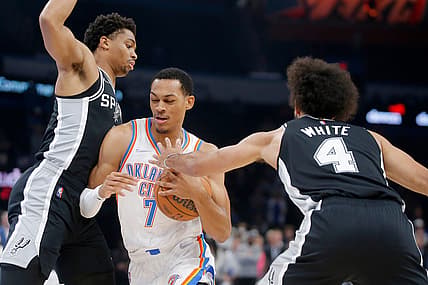 Oklahoma City's Darius Bazley (7) tries to drive to the basket between San Antonio's Keldon Johnson (3) and Derrick White (4) on Sunday night at Paycom Center.

bazley2