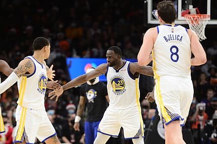 Dec 25, 2021; Phoenix, Arizona, USA; Golden State Warriors forward Draymond Green (23) celebrates with teammates against the Phoenix Suns during the second half at Footprint Center. Mandatory Credit: Joe Camporeale-USA TODAY Sports