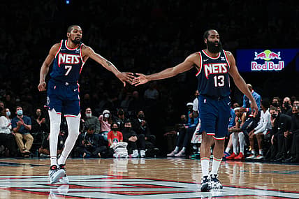 Dec 30, 2021; Brooklyn, New York, USA; Brooklyn Nets forward Kevin Durant (7) slaps hands with Brooklyn Nets guard James Harden (13) during the second half against the Philadelphia 76ers at Barclays Center. Mandatory Credit: Vincent Carchietta-USA TODAY Sports