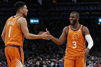 Dec 31, 2021; Boston, Massachusetts, USA; Phoenix Suns guard Chris Paul (3) and guard Devin Booker (1) celebrate after a basket against the Boston Celtics during the second half at TD Garden. Mandatory Credit: Winslow Townson-USA TODAY Sports