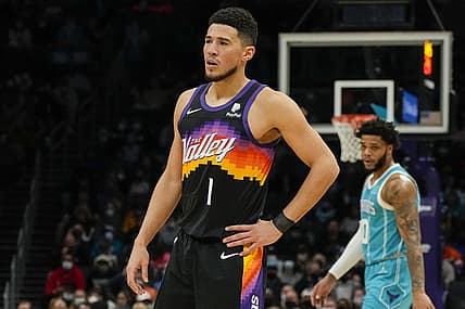 Jan 2, 2022; Charlotte, North Carolina, USA; Phoenix Suns guard Devin Booker (1) looks on against the Charlotte Hornets during the first quarter at the Spectrum Center. Mandatory Credit: Jim Dedmon-USA TODAY Sports