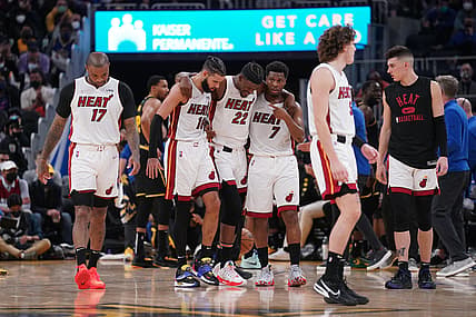 Jan 3, 2022; San Francisco, California, USA; Miami Heat forward Jimmy Butler (22) is helped to his feel by forward Caleb Martin (16) and guard Kyle Lowry (7) after suffering an injury against the Golden State Warriors in the third quarter at the Chase Center. Mandatory Credit: Cary Edmondson-USA TODAY Sports