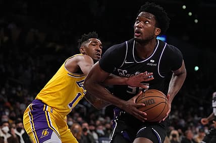Jan 4, 2022; Los Angeles, California, USA; Sacramento Kings center Damian Jones (30) is defended by Los Angeles Lakers guard Malik Monk (11) in the first half at Crypto.com Arena. Mandatory Credit: Kirby Lee-USA TODAY Sports