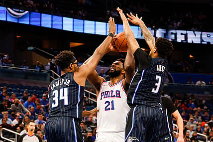 Jan 5, 2022; Orlando, Florida, USA;  Philadelphia 76ers center Joel Embiid (21) attempts a shot in the second quarter defended by Orlando Magic center Wendell Carter Jr. (34) and forward Chuma Okeke (3) at Amway Center. Mandatory Credit: Nathan Ray Seebeck-USA TODAY Sports