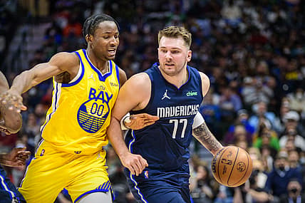 Jan 5, 2022; Dallas, Texas, USA; Golden State Warriors forward Jonathan Kuminga (00) guards Dallas Mavericks guard Luka Doncic (77) during the second quarter at the American Airlines Center. Mandatory Credit: Jerome Miron-USA TODAY Sports