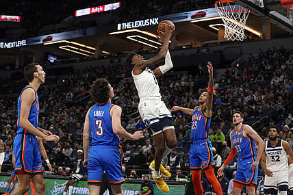 Jan 5, 2022; Minneapolis, Minnesota, USA;  Minnesota Timberwolves forward Jaden McDaniels (3) would get the basket and the foul on this play with Oklahoma City Thunder guard Tre Mann (23) during the second quarter at Target Center. Mandatory Credit: Nick Wosika-USA TODAY Sports