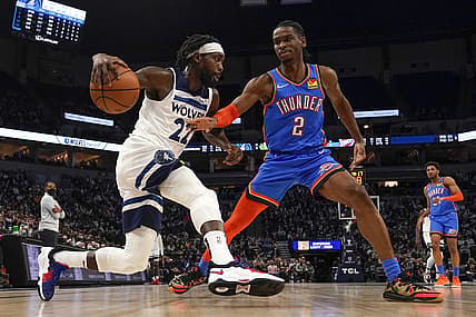 Jan 5, 2022; Minneapolis, Minnesota, USA;  Minnesota Timberwolves guard Patrick Beverley (22) drives to the basket as Oklahoma City Thunder guard Shai Gilgeous-Alexander (2) defends during the third quarter at Target Center. Mandatory Credit: Nick Wosika-USA TODAY Sports