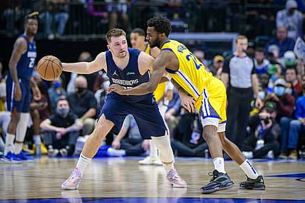 Jan 5, 2022; Dallas, Texas, USA; Golden State Warriors forward Andrew Wiggins (22) defends against Dallas Mavericks guard Luka Doncic (77) during the game between the Dallas Mavericks and the Golden State Warriors at the American Airlines Center. Mandatory Credit: Jerome Miron-USA TODAY Sports