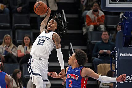 Jan 6, 2022; Memphis, Tennessee, USA; Memphis Grizzles guard Ja Morant (12) attempts to save a ball form going out of bounds during the first half against the Detroit Pistons at FedExForum. Mandatory Credit: Petre Thomas-USA TODAY Sports