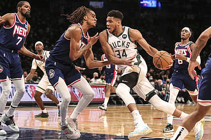 Jan 7, 2022; Brooklyn, New York, USA;  Milwaukee Bucks forward Giannis Antetokounmpo (34) drives past Brooklyn Nets forward Nic Claxton (33) in the first quarter at Barclays Center. Mandatory Credit: Wendell Cruz-USA TODAY Sports