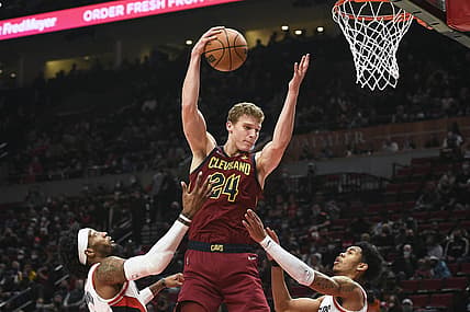 Jan 7, 2022; Portland, Oregon, USA;  Cleveland Cavaliers forward Lauri Markkanen (24) takes a pass inside during the first half against Portland Trail Blazers forward Robert Covington (33), left, and guard Anfernee Simons (1) at Moda Center. Mandatory Credit: Troy Wayrynen-USA TODAY Sports