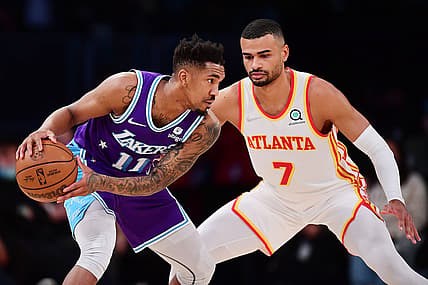 Jan 7, 2022; Los Angeles, California, USA; Los Angeles Lakers guard Malik Monk (11) controls the ball against Atlanta Hawks guard Timothe Luwawu-Cabarrot (7) during the first half at Crypto.com Arena. Mandatory Credit: Gary A. Vasquez-USA TODAY Sports